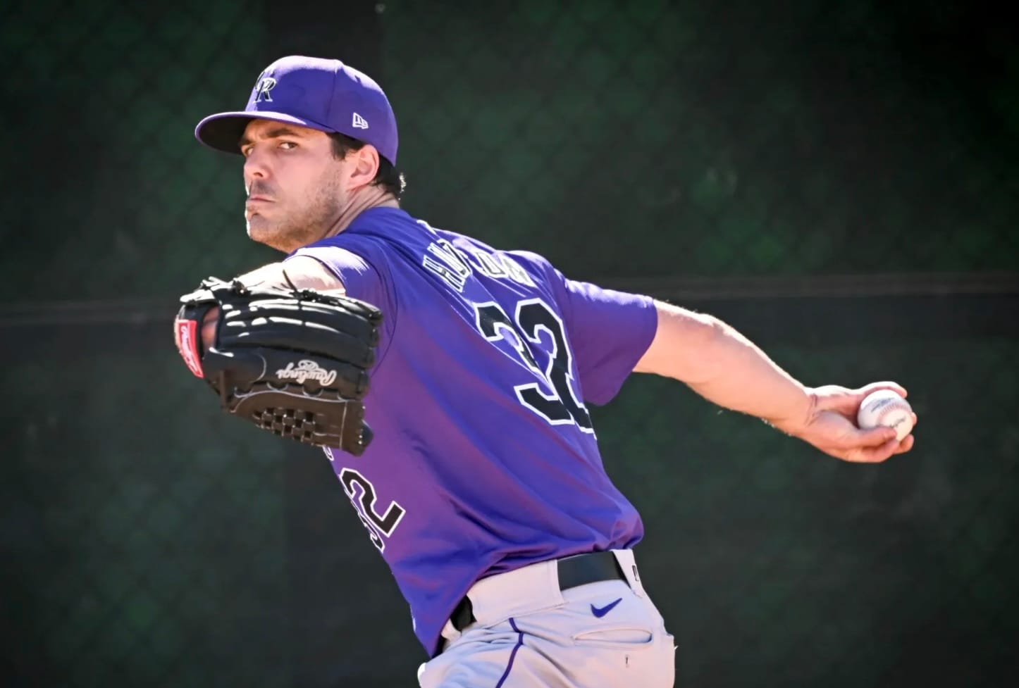 Dakota Hudson prepares to pitch. He’s wearing a purple jersey and looks very focused.