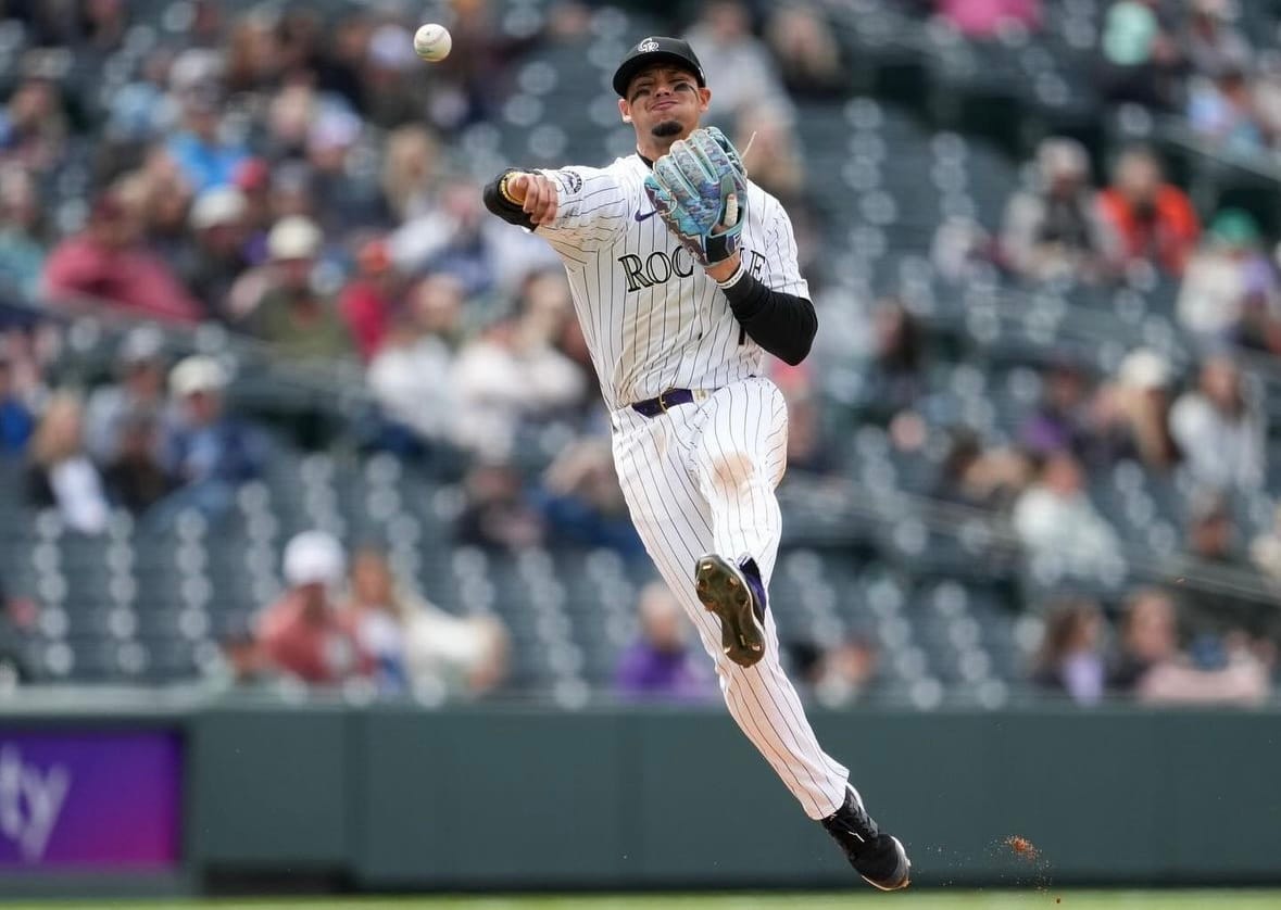 Tovar, on the run, throws to first. He’s wearing purple pinstripes.