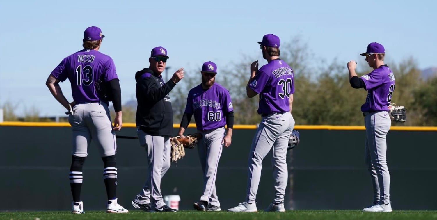 Ron Gideon works with Rockies outfielders.