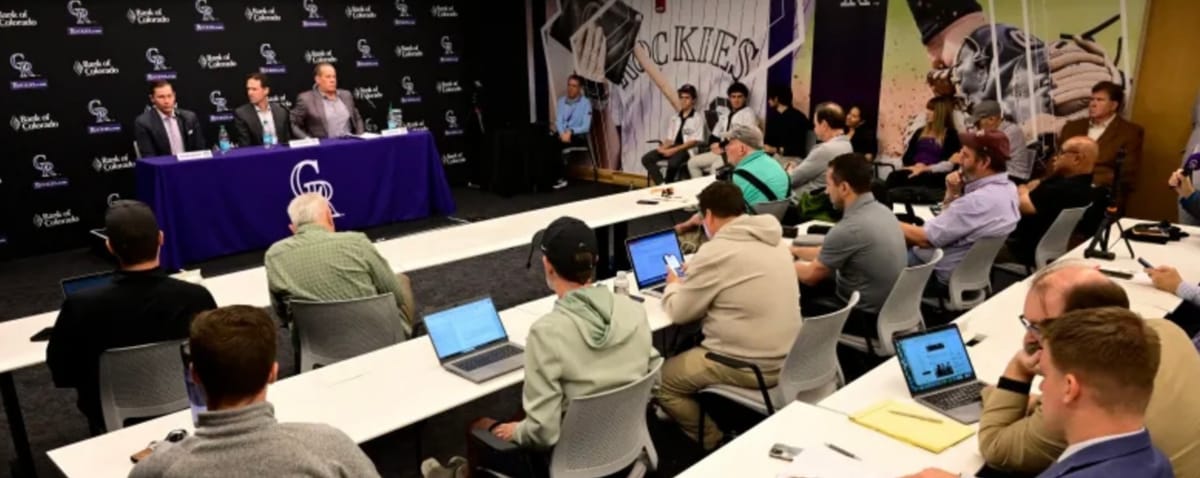 The Monforts and Paul DePodesta answer questions from media at Coors Field. 