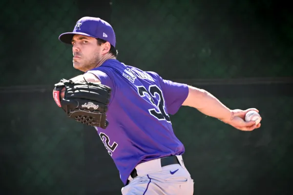 Dakota Hudson prepares to pitch. He’s wearing a purple jersey and hat and looking fierce.