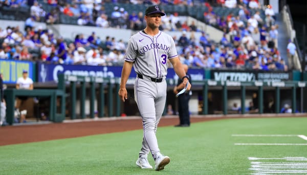 Schaeffer wears the Rockies road grays as he walks to home plate.